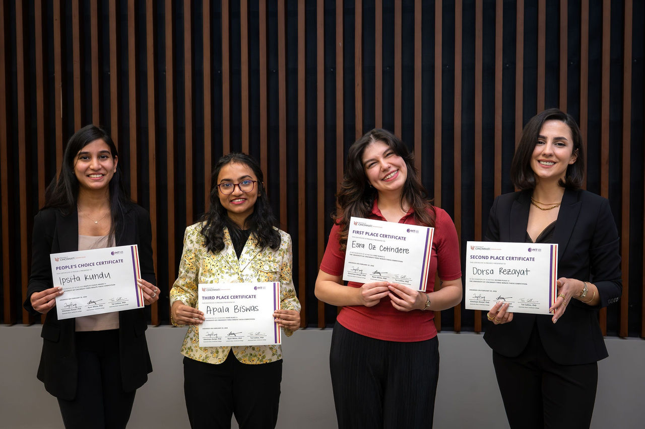Four women standing side by side holding certificates for first, second, third place, and people's choice awards.